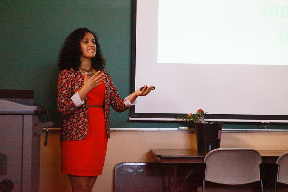 A student delivers a senior project thesis at the front of a classroom