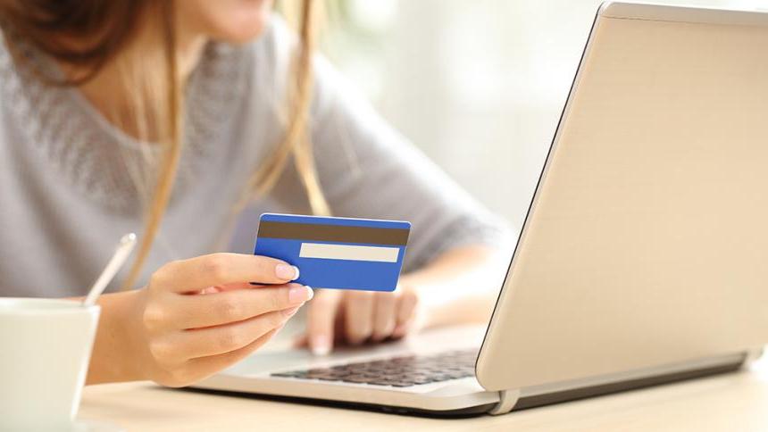 Woman at laptop with credit card